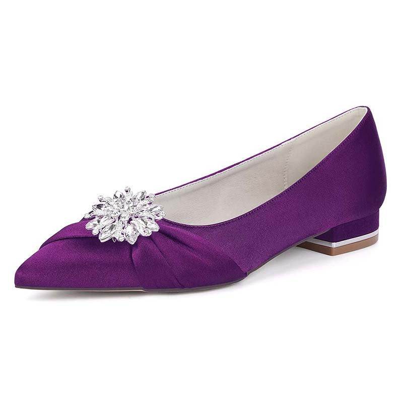 Purple shoe with a decorative brooch on a white background