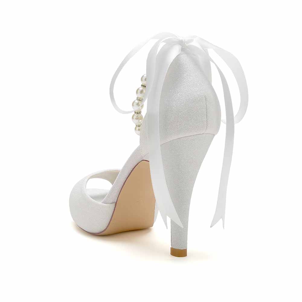 Elegant bridal shoes with pearls and ribbon for a stylish wedding look