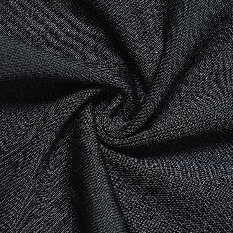 Close-up of luxurious fabric for a black halter neck rhinestone dress showcasing its texture