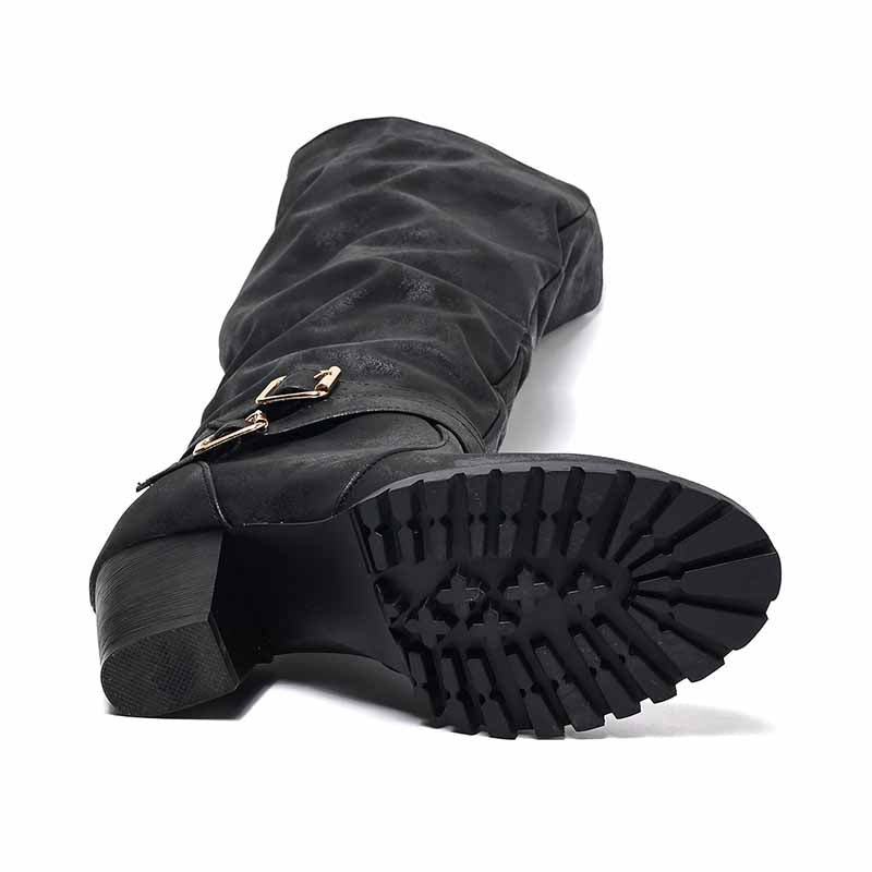 Black chunky heel knee-high boots featuring textured upper and durable treaded outsole