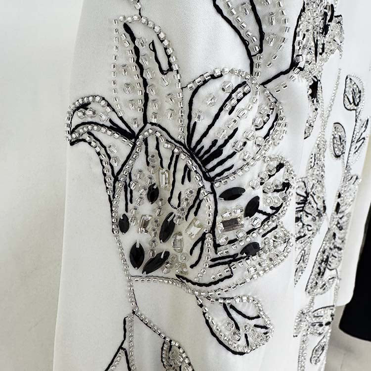 Close-up of an embellished evening gown for prom featuring intricate beaded floral designs