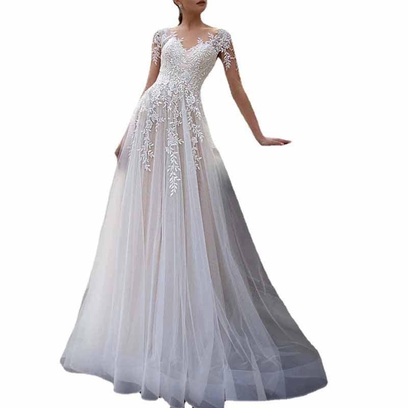 Elegant lace boho wedding dress with intricate floral embroidery and flowing tulle skirt