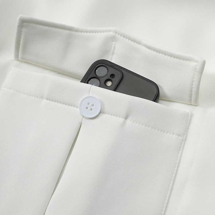 Close-up of off-white belted mini dress with pockets featuring a smartphone inside for convenient storage