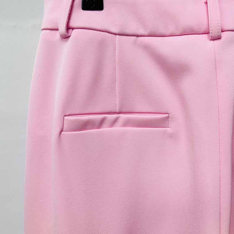 Close-up of a pink women's pantsuit for wedding featuring a smooth fabric and tailored pocket detail