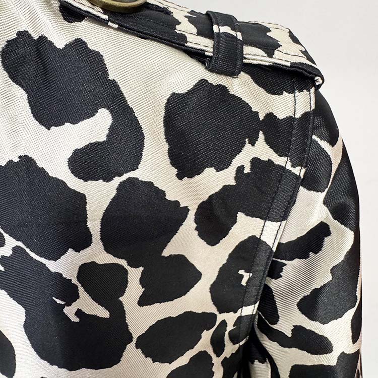 Close-up of a tailored animal print long coat featuring a stylish black and white design