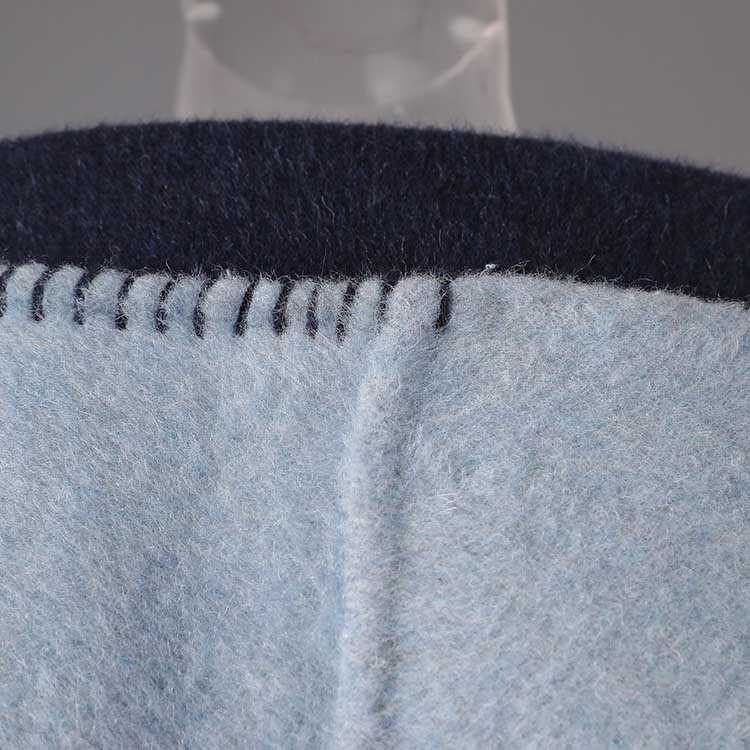 Close-up of a two-sided winter coat women featuring soft fabric and tailored stitching details