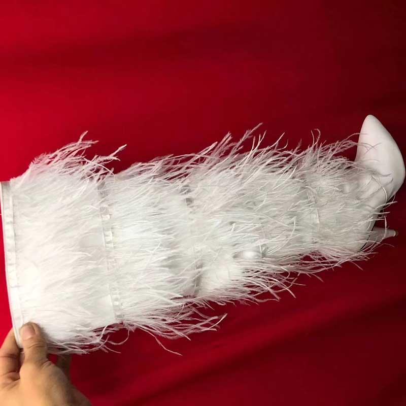 Stylish white faux fur boots for women with dramatic feather detailing and a sleek design