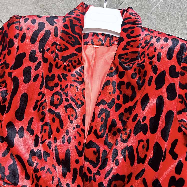 Close-up of a slim fit animal print suit for women in vibrant red and black with a sleek collar design