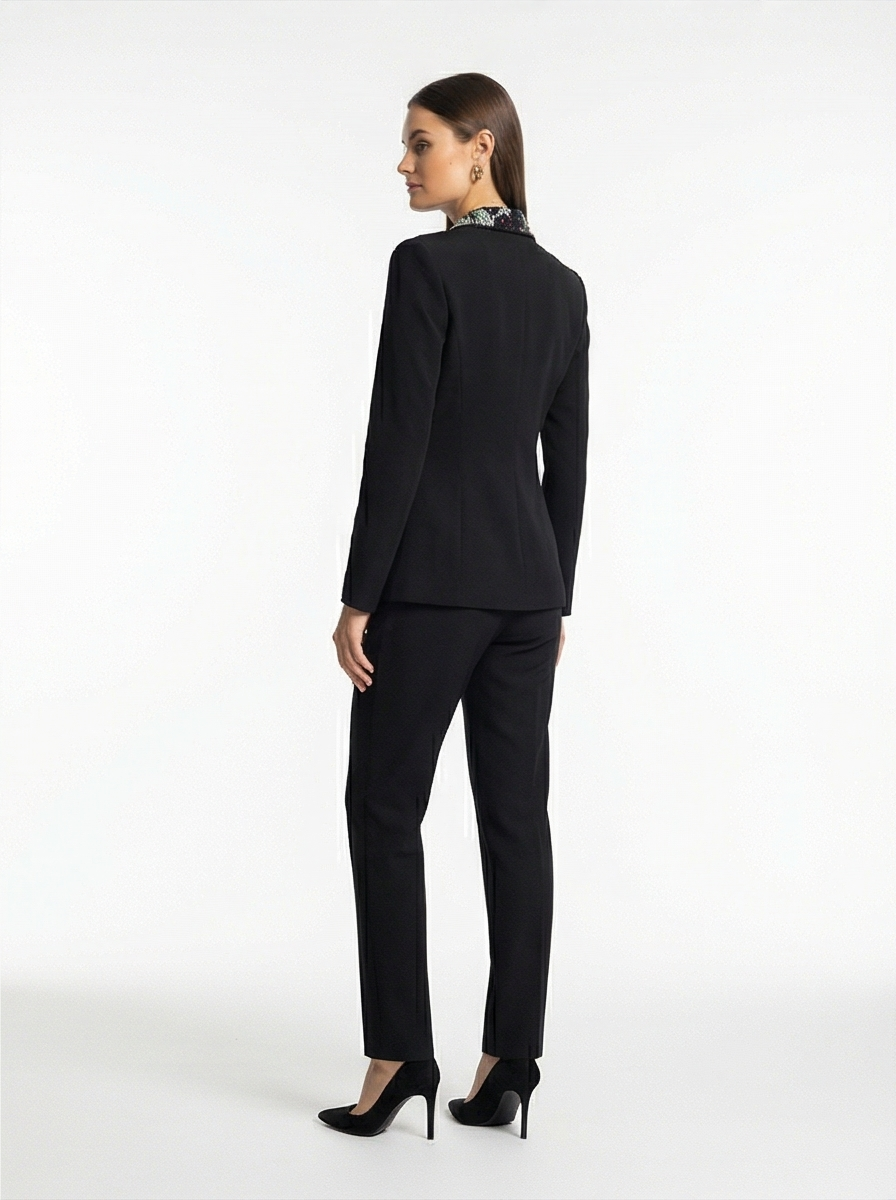 Woman wearing a black suit on a white background
