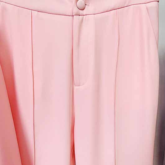 Close-up of a pink blazer pantsuit for women featuring tailored fit and stylish design