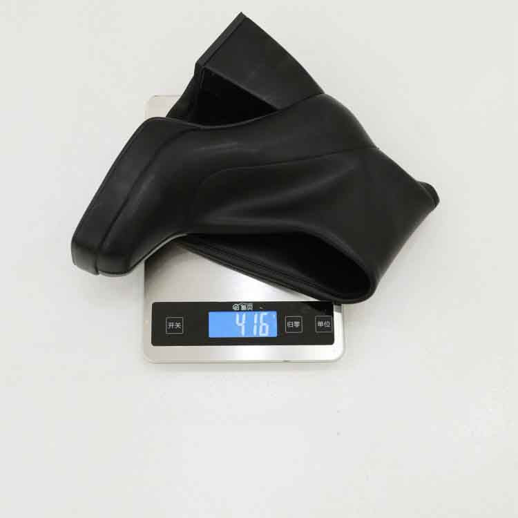 Stylish black knee high boots displayed on a digital scale showing their weight