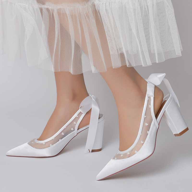 Elegant women's block heel wedding shoes with sheer panel and bow detail, perfect for brides