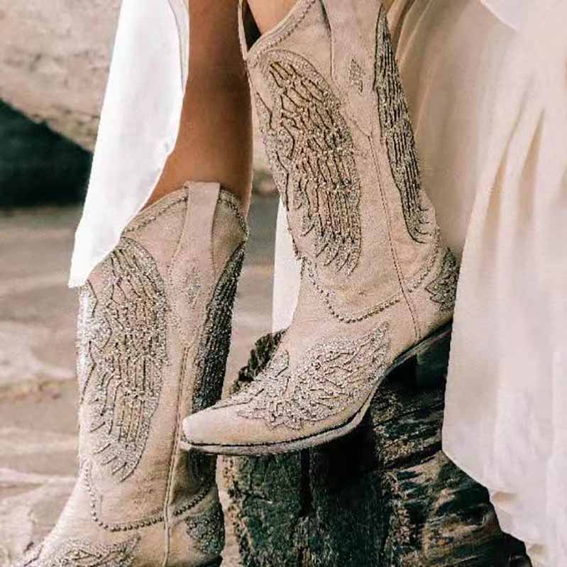 Elegant women's white western wedding boots with intricate embroidery and wing design for bridal style