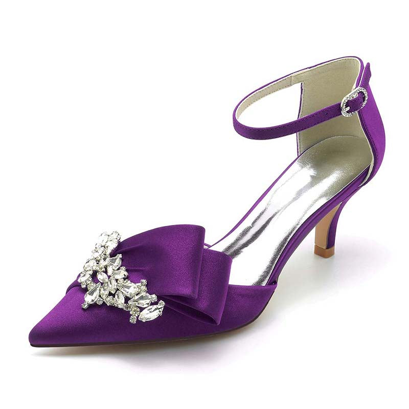 Purple high-heeled shoe with a bow and embellishments on a white background