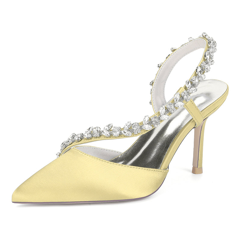 Yellow high-heeled shoe with crystal embellishments on a white background