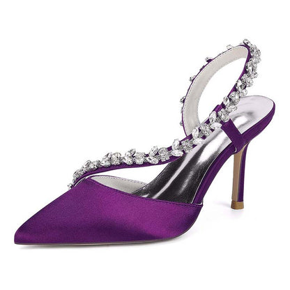Purple high-heeled shoe with crystal embellishments on a white background