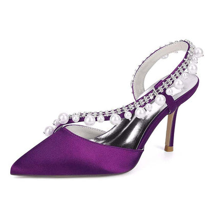 Purple high-heeled shoe with pearl embellishments on a white background