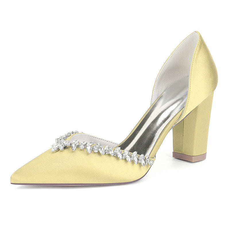Yellow high-heeled shoe with crystal embellishments on a white background