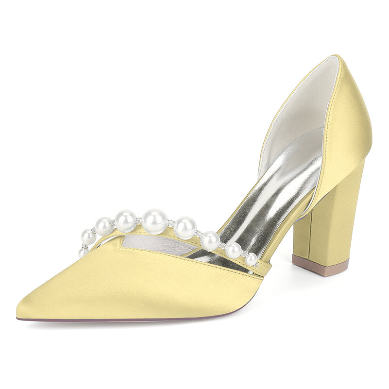 Yellow high-heeled shoe with pearl embellishments on a white background