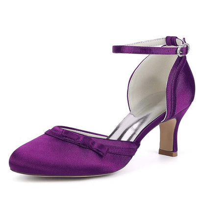 Purple satin shoe with a bow and ankle strap on a white background