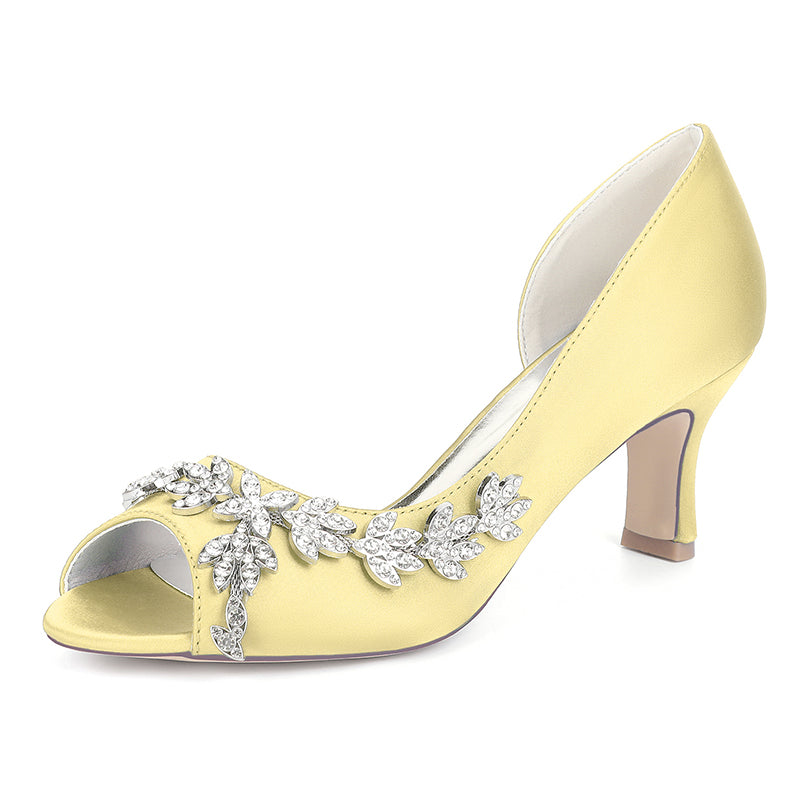 Yellow high-heeled shoe with decorative elements on a white background