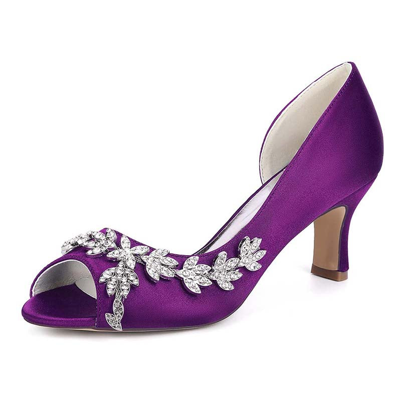 Purple high-heeled shoe with decorative elements on a white background