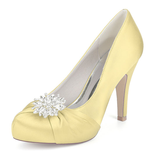 Yellow high-heeled shoe with a decorative flower on a white background