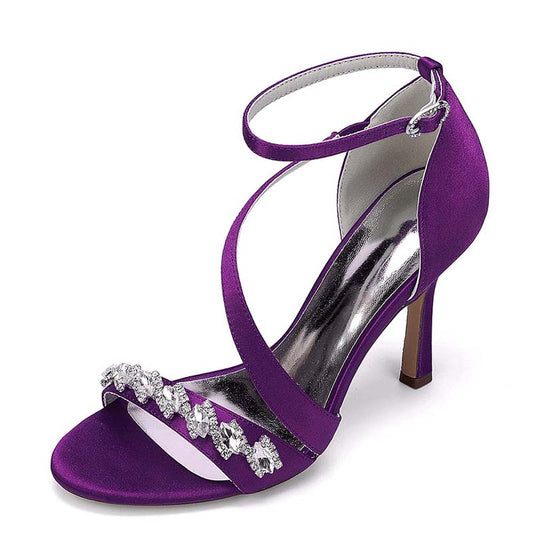 Purple high-heeled sandal with rhinestone embellishments on a white background