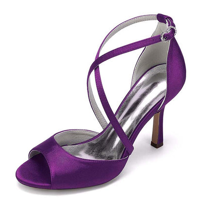 Purple high-heeled sandal with a strappy design on a white background
