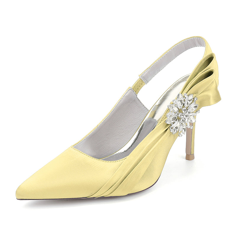 Yellow high-heeled shoe with a decorative flower on a white background