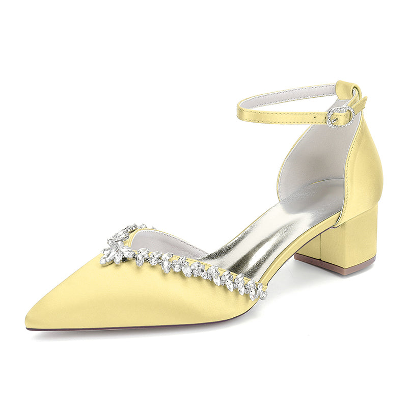 Yellow high-heeled shoe with crystal embellishments on a white background