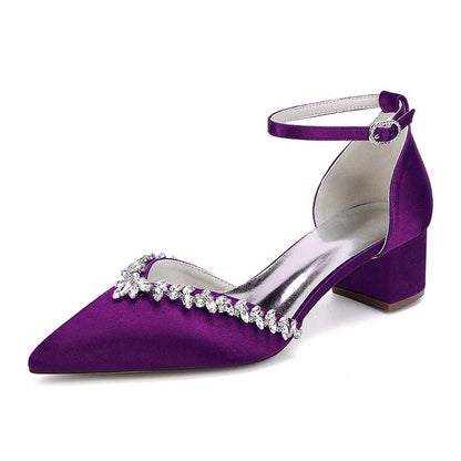 Purple high-heeled shoe with crystal embellishments on a white background