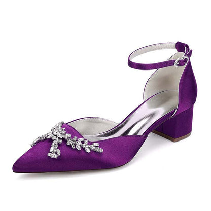Purple high-heeled shoe with decorative embellishments on a white background