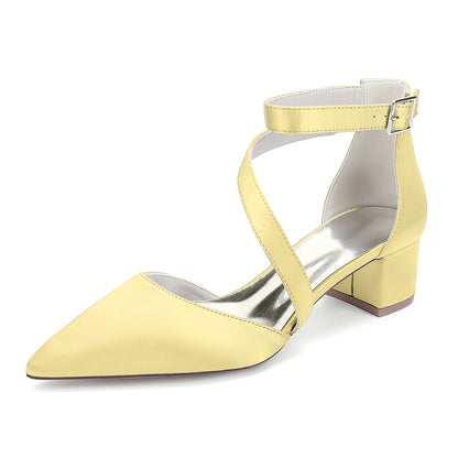Yellow high-heeled shoe with a silver sole on a white background