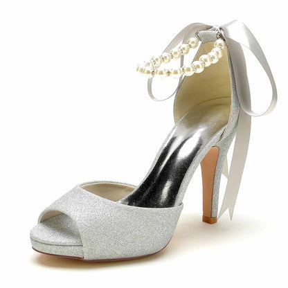 Silver bridal shoes with pearls and ribbon featuring a stylish open-toe design