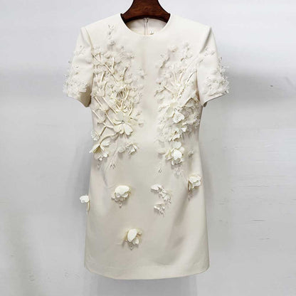 White dress with floral embellishments on a white background