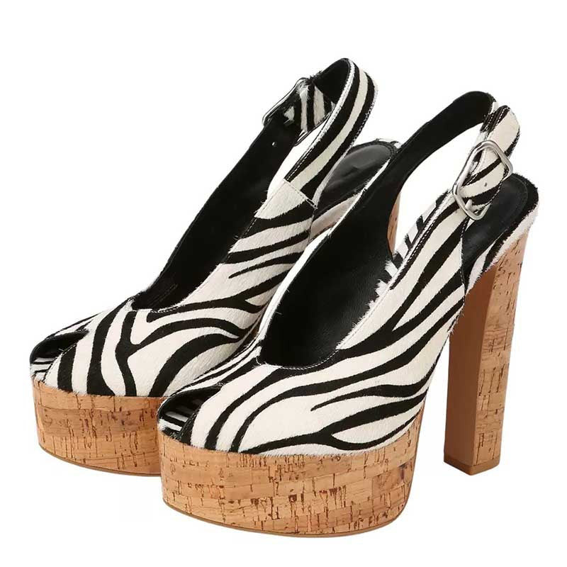 A pair of women's slingback high-heeled shoes with a black and white zebra print upper and natural cork platform soles, shown against a plain white background.