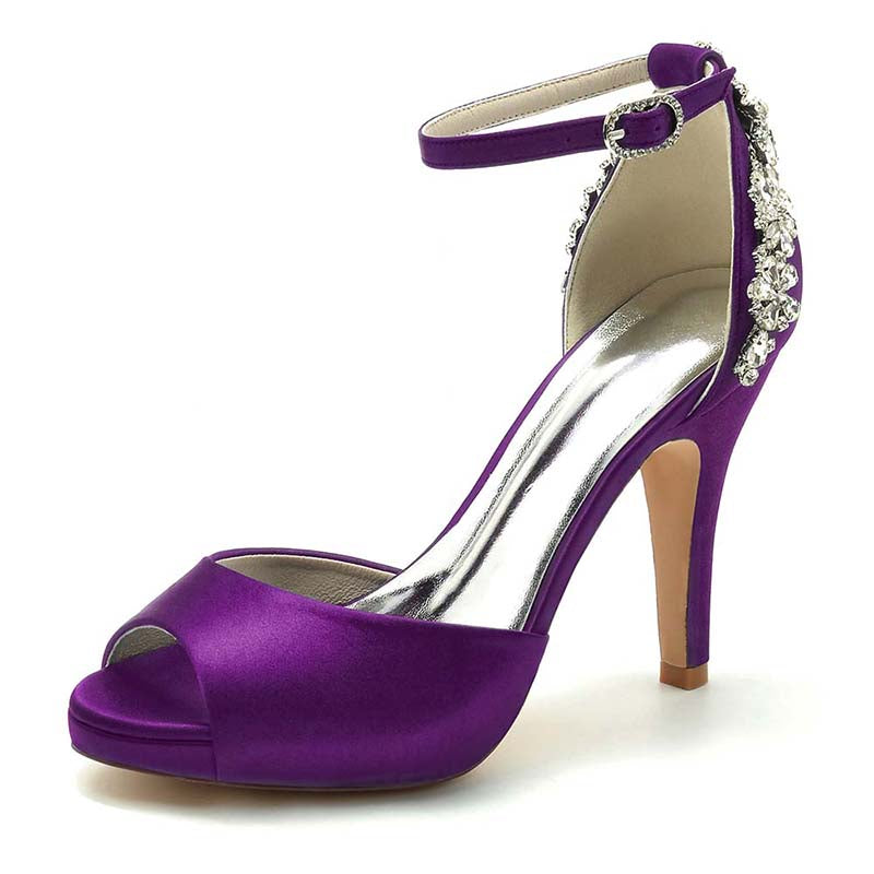 Purple high-heeled shoe with rhinestone details on a white background