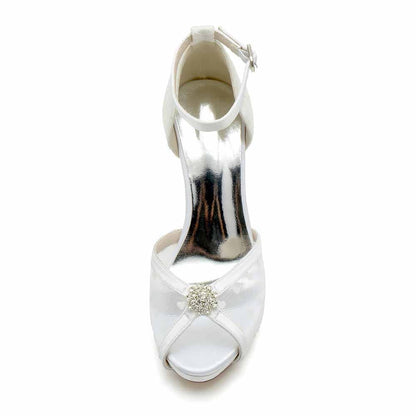 Elegant wedding pumps with lace and a sparkling embellishment for bridal occasions