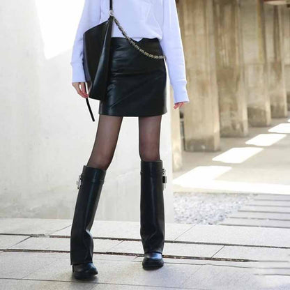 Stylish women's padlock knee high boots paired with a black leather skirt for a chic look