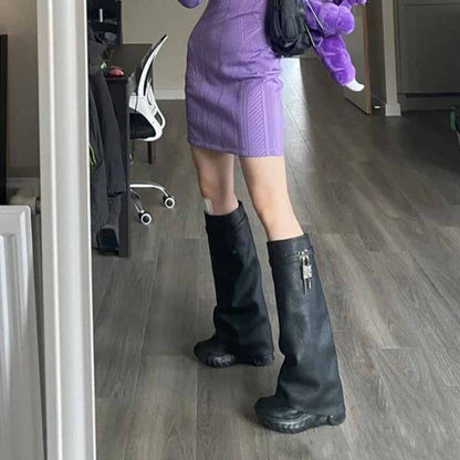 Trendy women's padlock knee high boots paired with a stylish purple dress for a chic look