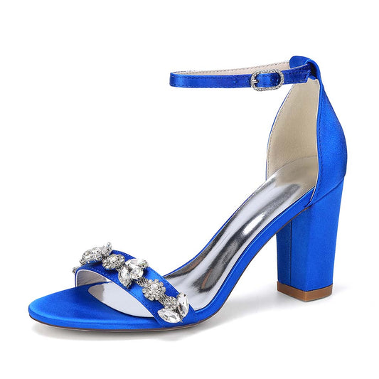 Blue high-heeled sandal with decorative straps on a white background