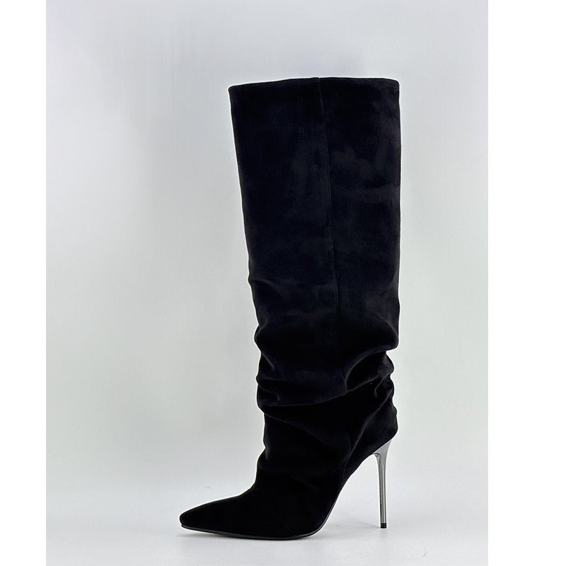 Black knee-high boot with a pointed toe and high heel on a white background