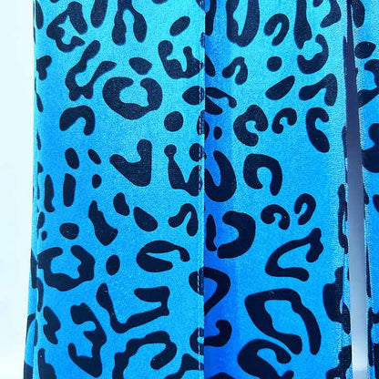 Close-up of women's leopard print velvet pantsuit in vibrant blue with bold animal pattern