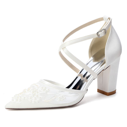 White high-heeled shoe with strappy design on a white background