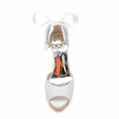 Elegant ankle strap bridal pumps in white with a decorative bow and sparkling details