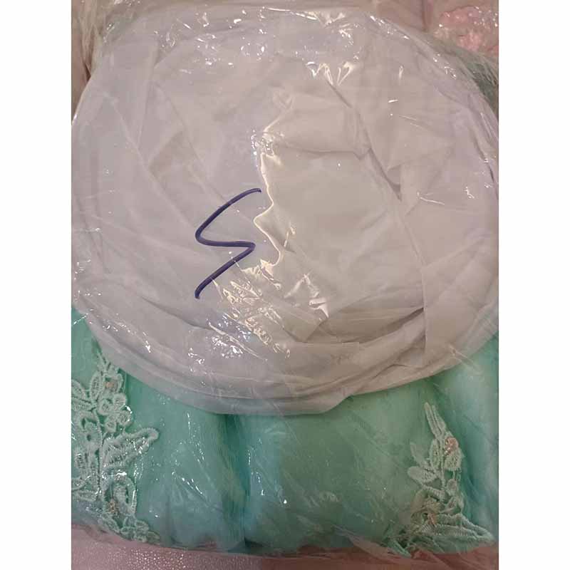 Beaded quinceanera dresses in mint green with intricate lace detailing, elegantly packaged for freshness