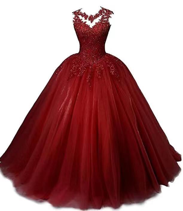 Elegant red beaded quinceanera dresses with a voluminous tulle skirt and intricate neckline detailing