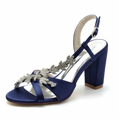 S&DCo. Beaded satin prom sandals in navy blue with stylish floral embellishments and a chunky heel