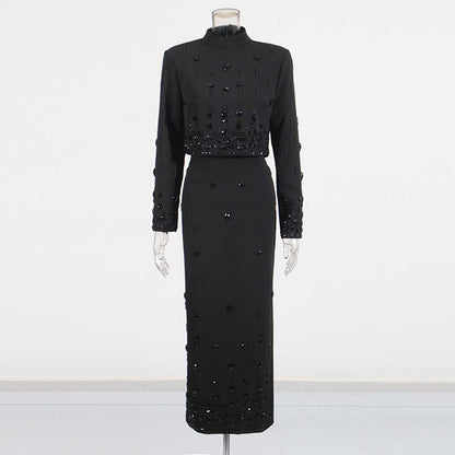 Elegant black beaded women's skirt suit with long sleeves and a fitted silhouette for formal occasions